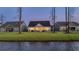 Beautiful backyard with a view of the water, patio, grill, and screened in porch at 357 Tupelo Lake Dr, Summerville, SC 29486