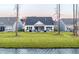 Beautiful backyard with a view of the water, patio, grill, and screened in porch at 357 Tupelo Lake Dr, Summerville, SC 29486