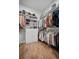 Organized walk-in closet with shelves, rods, drawers, and laminate floor at 357 Tupelo Lake Dr, Summerville, SC 29486