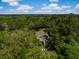 Aerial view of a home nestled among lush trees, featuring a serene deck, offering privacy and tranquility at 3627 Holmes Dr, Johns Island, SC 29455