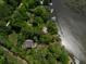 Overhead view features the beautiful waterfront property, multiple docks, and surrounding lush trees at 3627 Holmes Dr, Johns Island, SC 29455