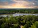Stunning aerial view showcasing the expansive property and its serene waterfront location surrounded by mature trees at 3627 Holmes Dr, Johns Island, SC 29455