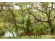 Idyllic backyard featuring a bench, chair, lush greenery, and serene water views for relaxing outdoors at 3627 Holmes Dr, Johns Island, SC 29455