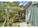 Inviting balcony with a wooden table and chairs, lush greenery, and a tranquil outdoor space at 3627 Holmes Dr, Johns Island, SC 29455