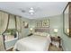 This bedroom has a queen bed, vintage side tables, and a beautiful window view at 3627 Holmes Dr, Johns Island, SC 29455