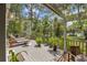Relaxing deck area with lounge chairs, dining table, lush plants, and tranquil outdoor setting at 3627 Holmes Dr, Johns Island, SC 29455