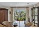 Dining room with wood table and chairs plus sliding door to deck overlooking waterfront landscape at 3627 Holmes Dr, Johns Island, SC 29455