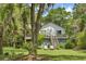 Charming two-story home with a spacious deck, stairs, and lush, green landscaping at 3627 Holmes Dr, Johns Island, SC 29455