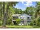Charming two-story home featuring a lovely deck, stairs, lush greenery, and a serene setting at 3627 Holmes Dr, Johns Island, SC 29455