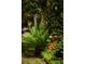 Landscaped yard featuring a palm tree, flowering plants, and tropical foliage at 3627 Holmes Dr, Johns Island, SC 29455