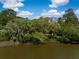 Tranquil waterfront property showcasing lush greenery and serene water views on a sunny day at 3627 Holmes Dr, Johns Island, SC 29455