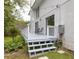 Relaxing deck with outdoor seating is enhanced by mature landscaping and home's brick exterior at 37 Fort Royal Ave, Charleston, SC 29407