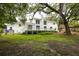 Backyard view featuring a deck, lush green grass, and mature trees at 37 Fort Royal Ave, Charleston, SC 29407