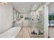 Bright bathroom featuring a glass-enclosed shower, double sinks, and soaking tub at 37 Fort Royal Ave, Charleston, SC 29407