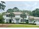 Charming two-story home with a well-manicured lawn, palm trees, and a light-blue front door at 37 Fort Royal Ave, Charleston, SC 29407