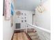 Bright hallway with a decorative chandelier, hardwood floors, and stylish artwork at 37 Fort Royal Ave, Charleston, SC 29407
