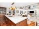 Open concept kitchen and living area with island seating and dark wood cabinets at 37 Fort Royal Ave, Charleston, SC 29407