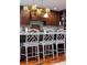 Elegant kitchen with an island, seating, designer lighting, and dark wood cabinetry at 37 Fort Royal Ave, Charleston, SC 29407