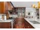 Modern kitchen with dark wood cabinets, stainless steel range, marble countertops, and hardwood flooring at 37 Fort Royal Ave, Charleston, SC 29407