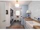 Well-organized laundry room with shaker cabinets, a butcher block countertop, and built-in storage at 37 Fort Royal Ave, Charleston, SC 29407