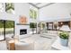 Bright living room with white fireplace, neutral furniture, high ceilings, and seamless access to outdoor deck at 37 Fort Royal Ave, Charleston, SC 29407