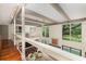 Bright living room features beautiful hardwood floors, high ceilings and lovely nature views at 37 Fort Royal Ave, Charleston, SC 29407