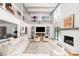 Bright and airy living room with high ceilings, fireplace, and large windows at 37 Fort Royal Ave, Charleston, SC 29407