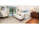 Cozy main bedroom with a sliding glass door leading to a private deck and white furniture at 37 Fort Royal Ave, Charleston, SC 29407