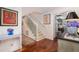 Staircase with hardwood floors, painted railing, and artwork on the wall, adding a touch of elegance at 37 Fort Royal Ave, Charleston, SC 29407