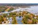 Aerial view of a home on the water surrounded by mature trees and greenery at 4215 Ten Shillings Way, Ravenel, SC 29470
