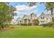 Beautiful home with a spacious backyard, screened porch, manicured lawn, and mature trees at 4215 Ten Shillings Way, Ravenel, SC 29470