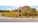 A spacious brick horse barn features lush landscaping, providing a functional yet aesthetically pleasing space at 4215 Ten Shillings Way, Ravenel, SC 29470