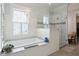 Bathroom with a tub and glass shower has white subway tile on the walls and marble countertops at 4215 Ten Shillings Way, Ravenel, SC 29470