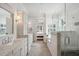 Bright bathroom with marble counters and tile floors leading into the Primary bedroom at 4215 Ten Shillings Way, Ravenel, SC 29470
