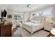 Bright bedroom with white walls and hardwood floors features a seating area next to a large bay window at 4215 Ten Shillings Way, Ravenel, SC 29470