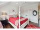 Well-lit bedroom with a four poster bed, decorative pillows, and hardwood floors at 4215 Ten Shillings Way, Ravenel, SC 29470