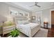 Bright bedroom features two dressers, bedside tables with lamps, and multiple windows providing ample natural light at 4215 Ten Shillings Way, Ravenel, SC 29470