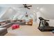 Spacious bonus room with vaulted ceiling, large sectional sofa, and exercise equipment at 4215 Ten Shillings Way, Ravenel, SC 29470
