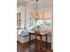 Cozy breakfast nook with window seat, cushions, table, and decorative chandelier at 4215 Ten Shillings Way, Ravenel, SC 29470