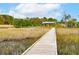 Waterfront home boasting a private dock and a gazebo, surrounded by scenic marshlands at 4215 Ten Shillings Way, Ravenel, SC 29470
