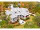 Beautiful home with a screened porch, outdoor dining space, and lush landscaping at 4215 Ten Shillings Way, Ravenel, SC 29470