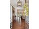 Inviting foyer with hardwood floors, decorative light fixture, barn door, and open view to the living room at 4215 Ten Shillings Way, Ravenel, SC 29470