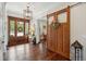 Elegant foyer featuring hardwood floors, decorative sliding barn door, and a view into the living space at 4215 Ten Shillings Way, Ravenel, SC 29470