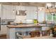 Bright kitchen with white cabinets, stainless steel appliances, butcher block island, and pendant lighting at 4215 Ten Shillings Way, Ravenel, SC 29470