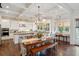 Bright, open kitchen with an eat-in area, white cabinetry, coffered ceilings, and hardwood floors at 4215 Ten Shillings Way, Ravenel, SC 29470