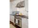 Kitchen appliances, including a Thermador stove with stainless steel hood, countertops, and cabinets at 4215 Ten Shillings Way, Ravenel, SC 29470