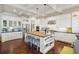 Spacious kitchen featuring a butcher block island, white cabinets, and stainless-steel appliances at 4215 Ten Shillings Way, Ravenel, SC 29470
