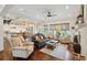 Bright, open concept living room with a fireplace, sofas, and an open flow to the kitchen at 4215 Ten Shillings Way, Ravenel, SC 29470