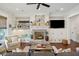 Living room with a fireplace, built-in shelves, a ceiling fan, and shiplap walls at 4215 Ten Shillings Way, Ravenel, SC 29470