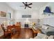 Living room has hardwood floors, white wainscoted walls, and comfortable seating, creating a relaxing ambiance at 4215 Ten Shillings Way, Ravenel, SC 29470
